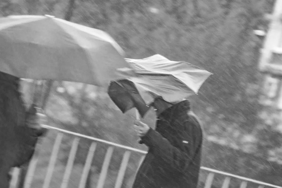 Blurred umbrellas in heavy rain